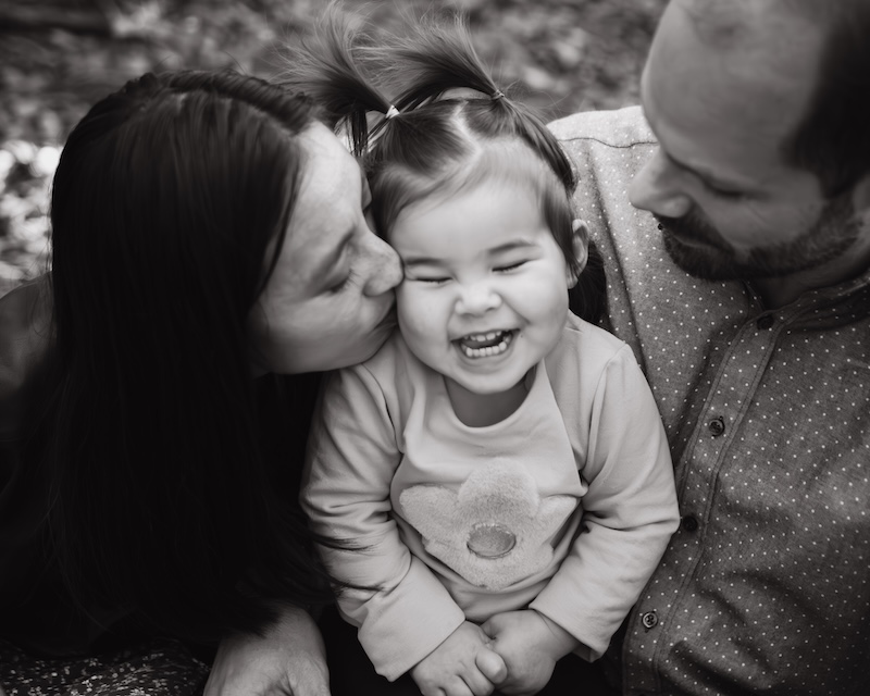 Happy parents with laughing toddler